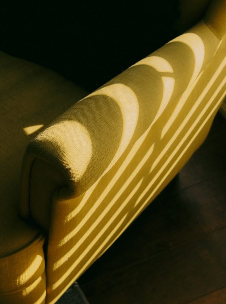 a close up of a chair with the sun shining on it imeb7tlqqq4