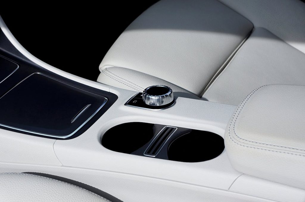 Close-up view of a luxury car interior showcasing elegant leather seats and control panel.
